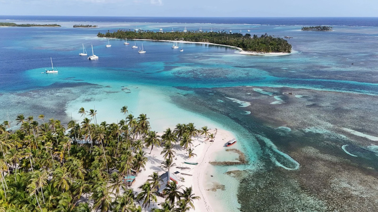 Palm-covered islands surrounded by turquoise reef in San Blas, Panama
